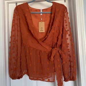ePretty burnt-orange fuzzy dot wrap shirt